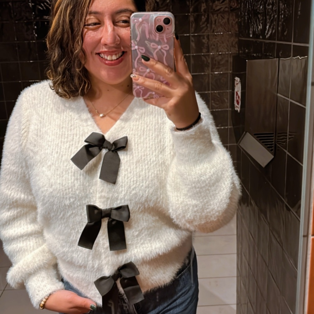 Elegant Cream Sweater with Black Bow Accents